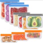 Eight gray reusable freezer bags of various sizes, with secure zipper closures, stacked neatly on a clean surface.