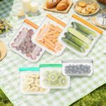 A set of twelve grey reusable silicone food storage bags in various sizes, including gallon, sandwich, and snack bags, with c