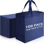 A stack of 100 navy blue reusable non-woven tote bags with handles, neatly folded and ready for use.