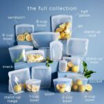 Four clear Stasher reusable silicone bags, including snack, sandwich, 2-cup, and 4-cup sizes, neatly arranged.